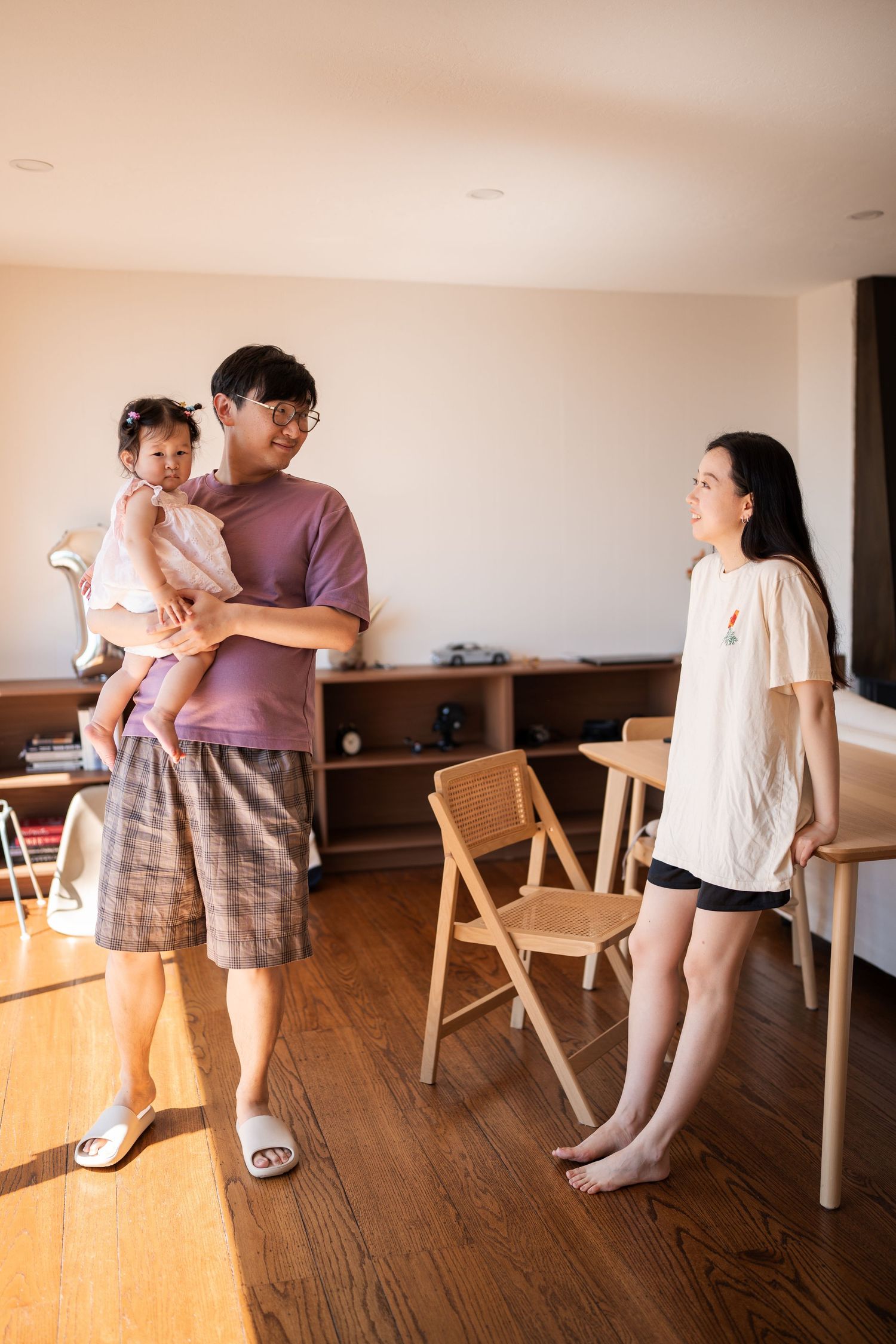 A sequence of images showing a playful dance lesson between two people in a sunlit room with wooden floors.