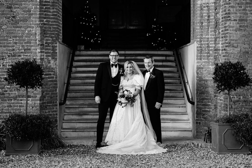 A series of black and white wedding photos showing couples posing in front of a brick building entrance.