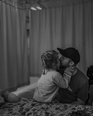 Intimate black and white photograph of tender moment between two people.