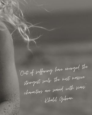 A quote by Khalil Gibran about suffering overlaid on an artistic black and white photograph.