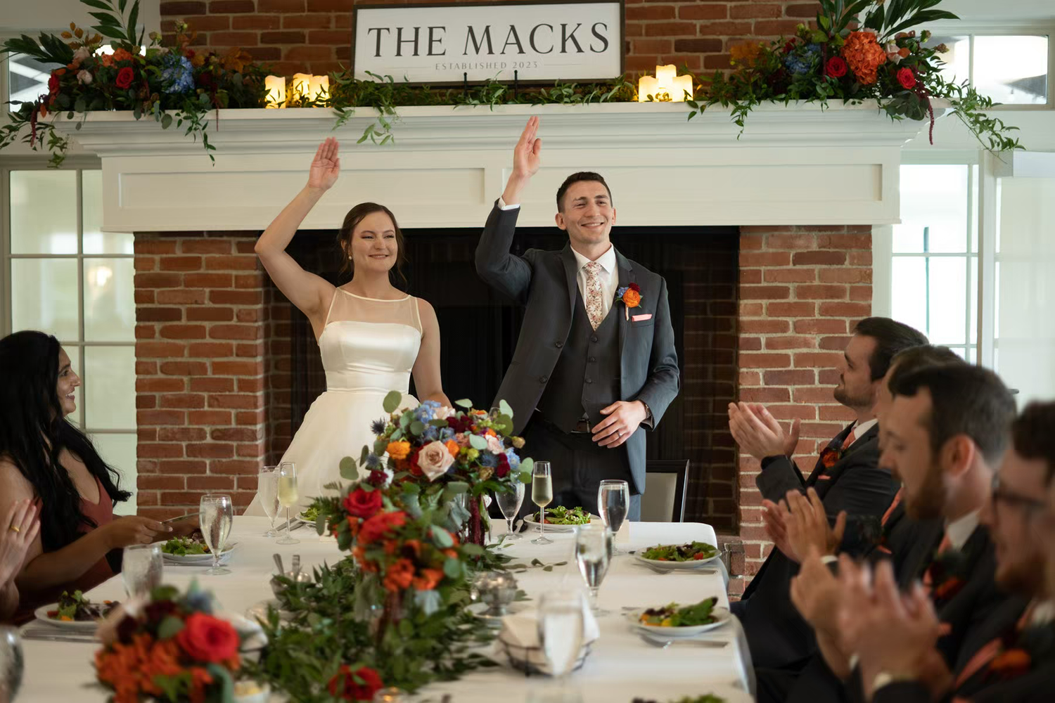 Nationwide Conference Center Wedding Newlyweds celebrate with raised hands during wedding reception