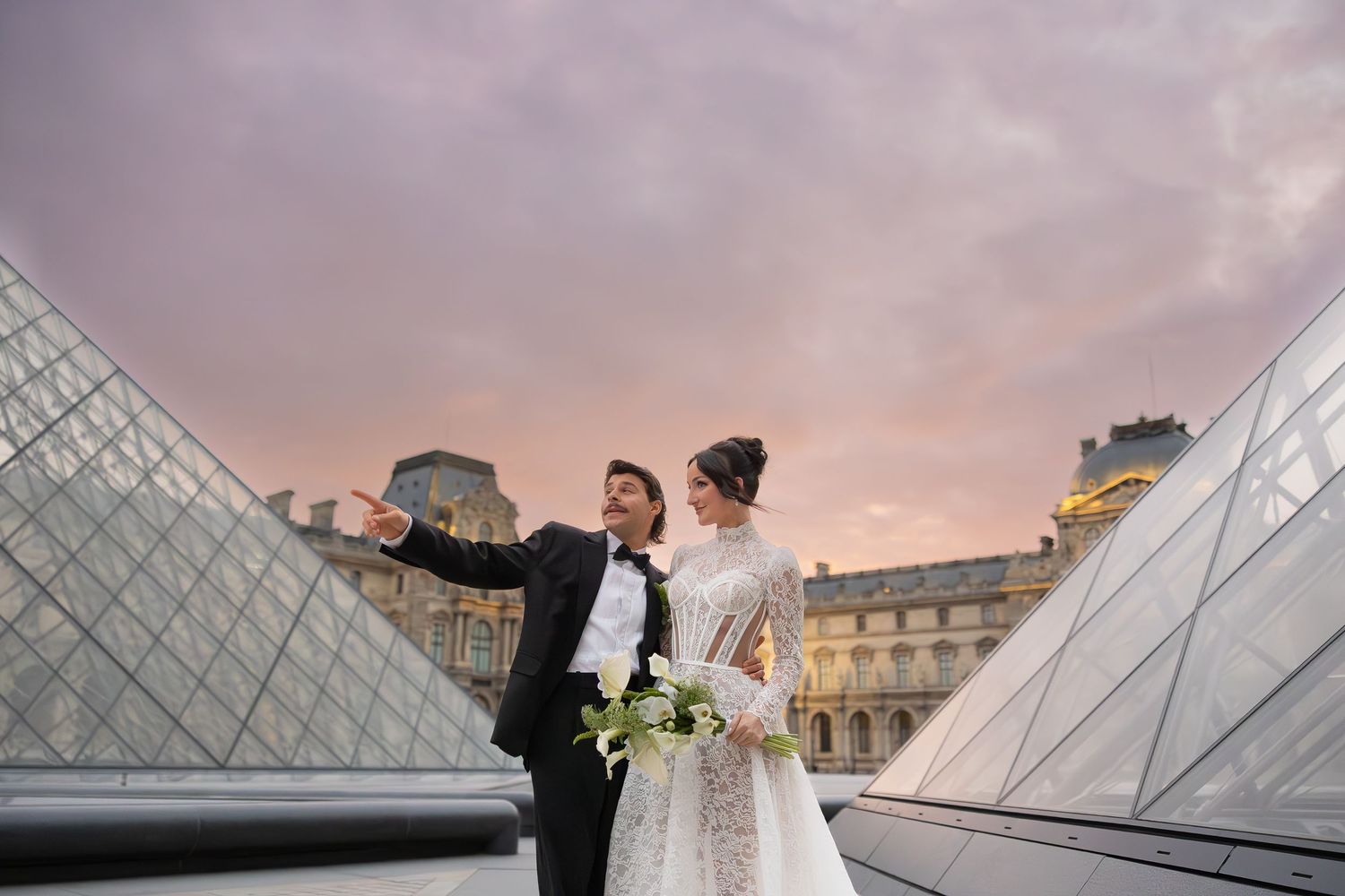Wedding photography session at the Louvre pyramid in Paris during sunset.
