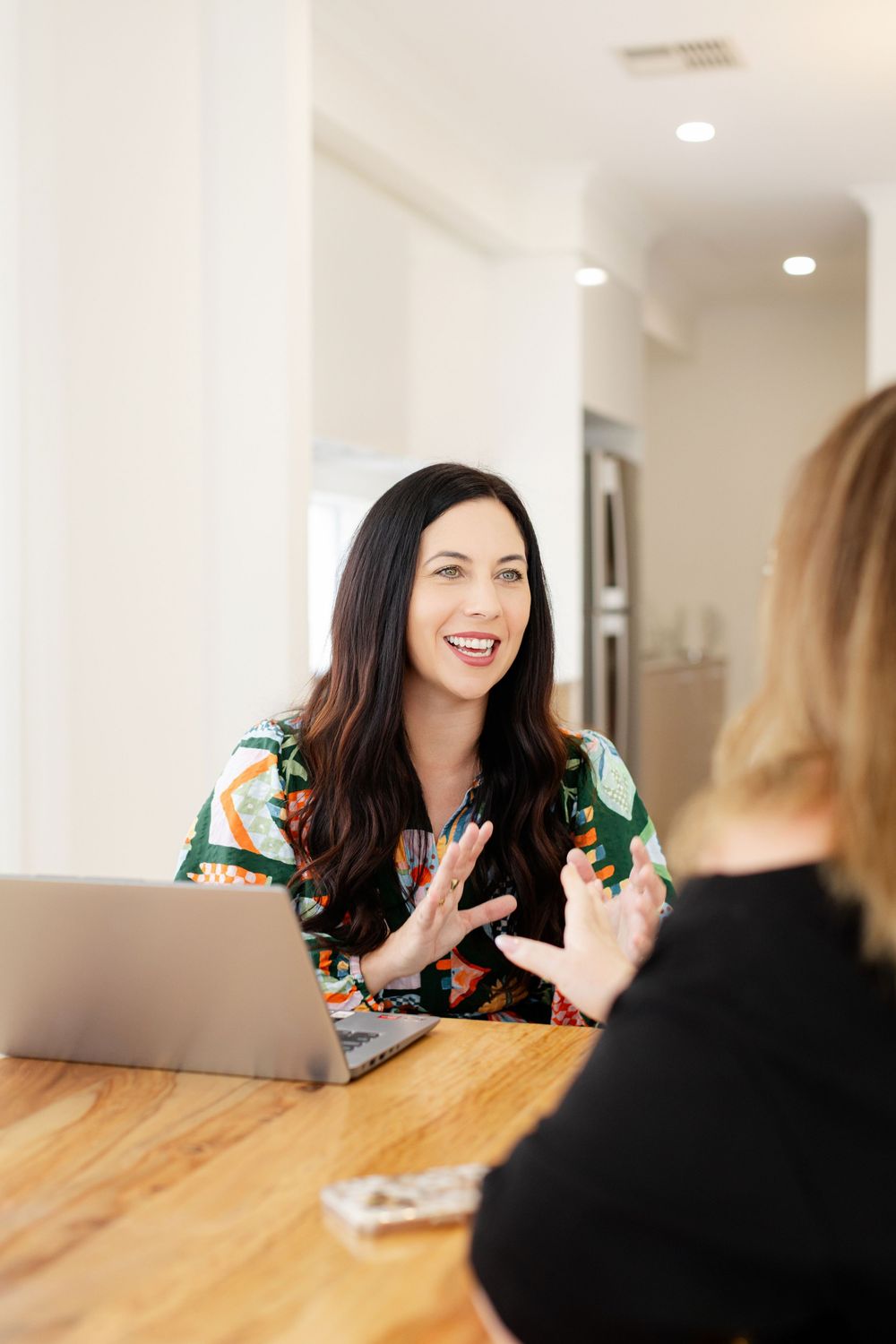 Two people having an animated conversation in a house to hire for Photoshoot