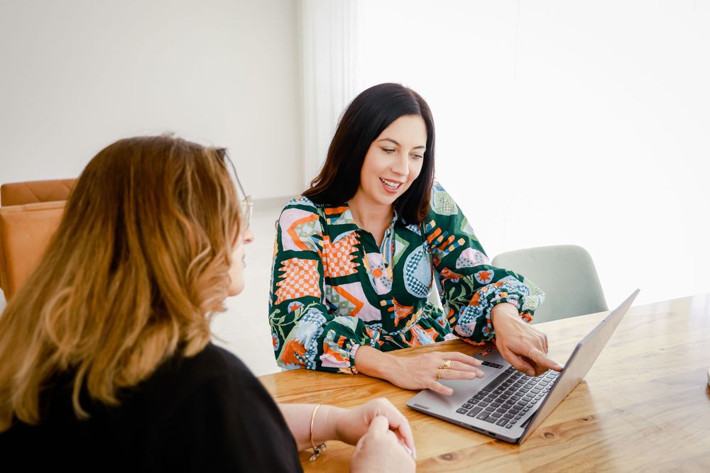 Two colleagues collaborating on a project in a house to hire for photoshoots