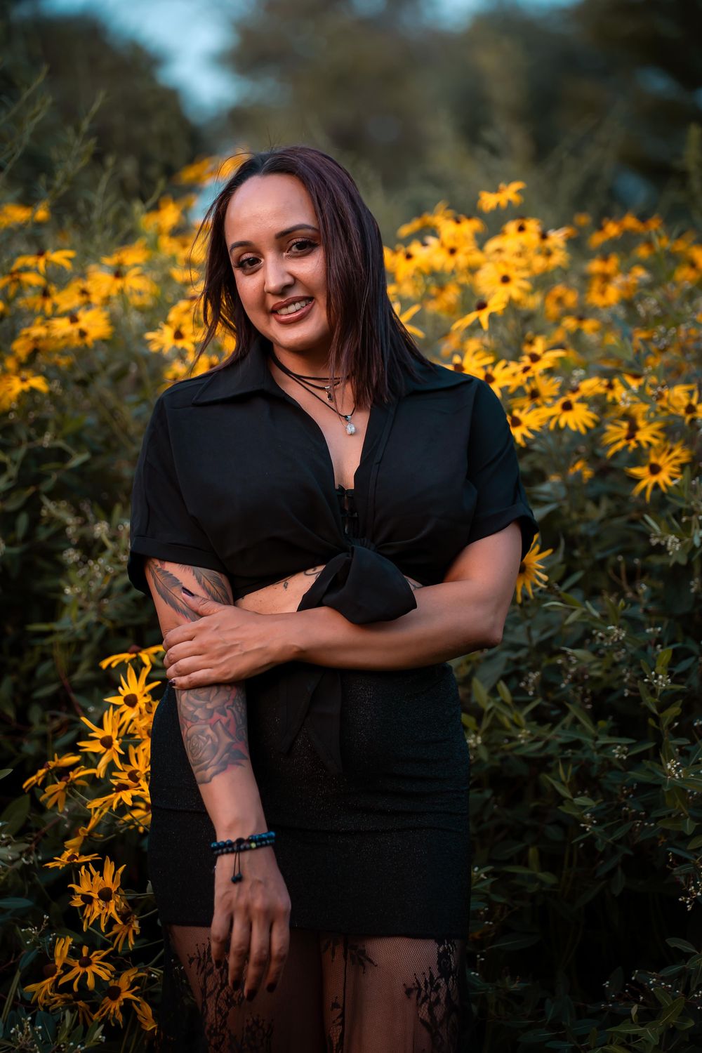 Artistic poses captured among vibrant yellow wildflowers in natural evening light.