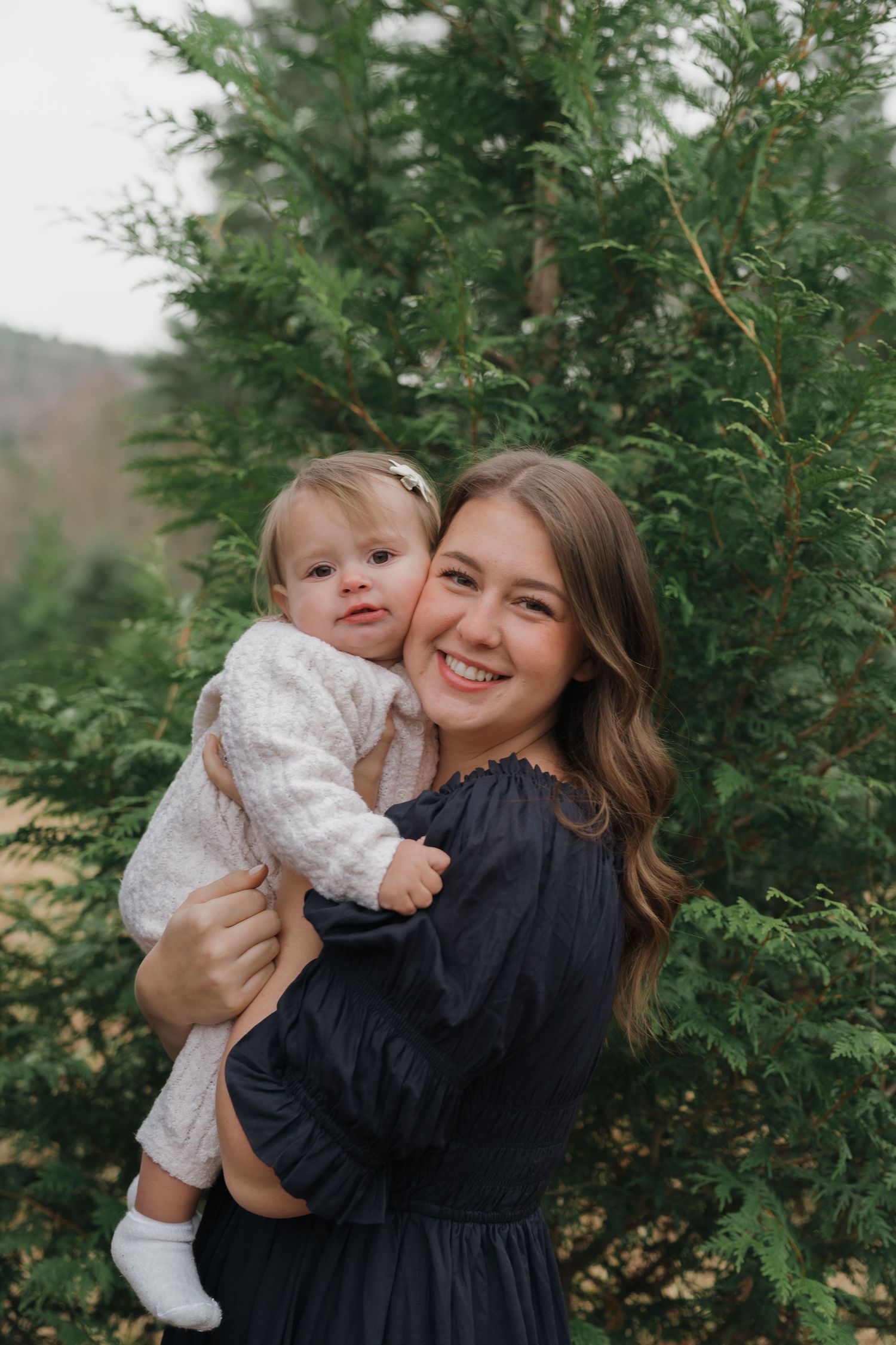 A series of joyful moments captured between parent and child against a backdrop of evergreen trees.