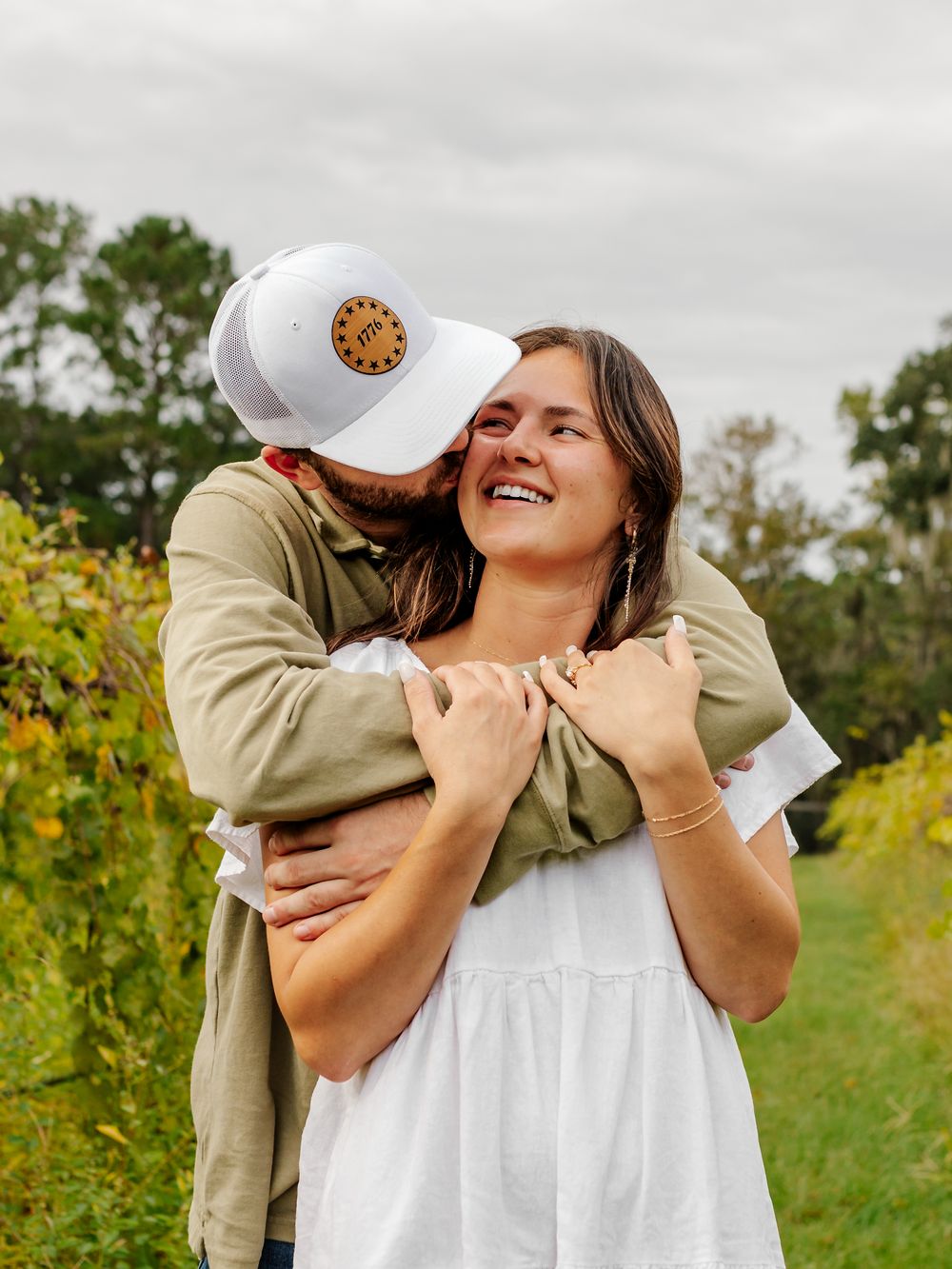 A surprise proposal unfolds in a sunny meadow with yellow wildflowers in the background.