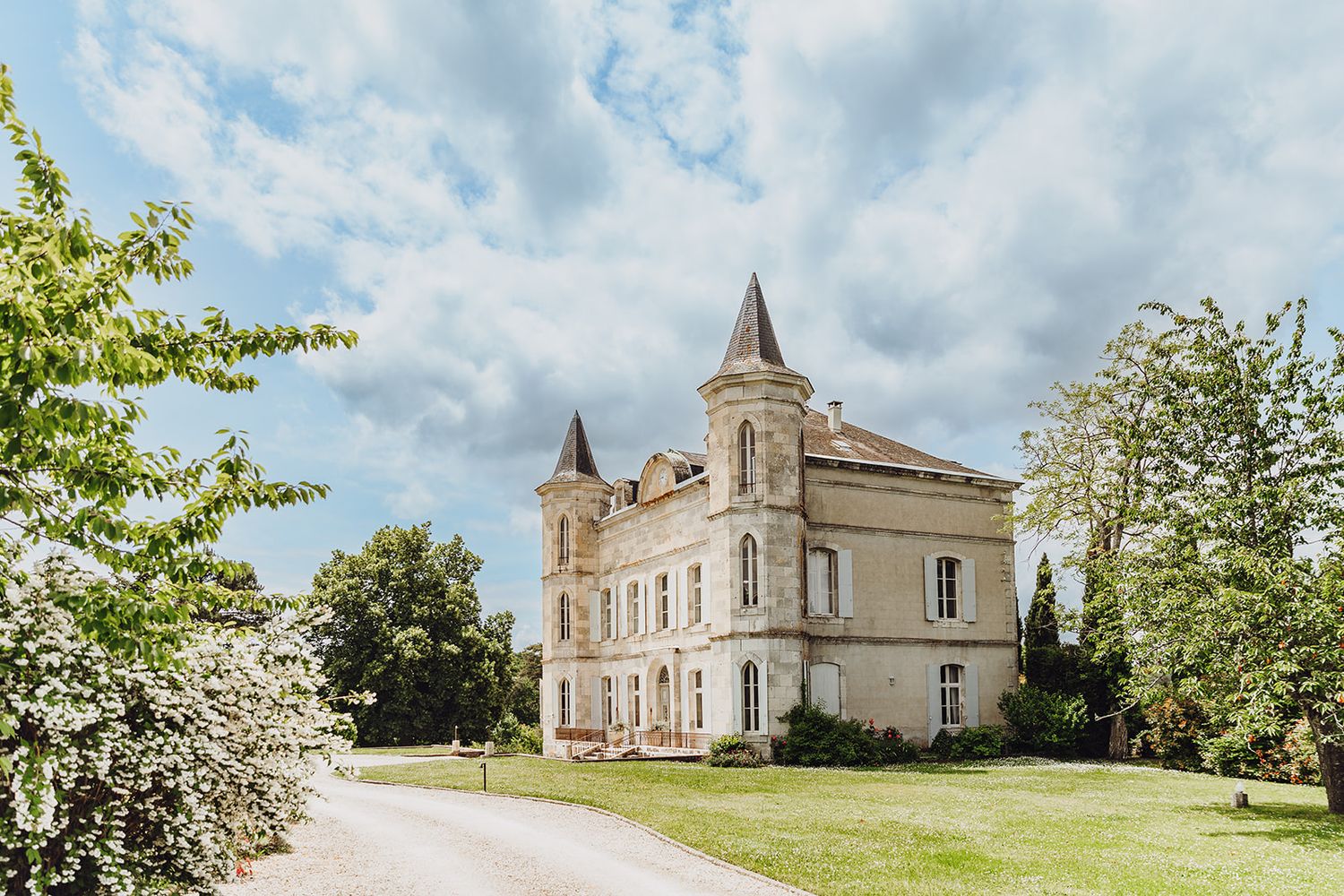Panoramic view of a French chateau wedding venue with manicured lawns and classic architecture.