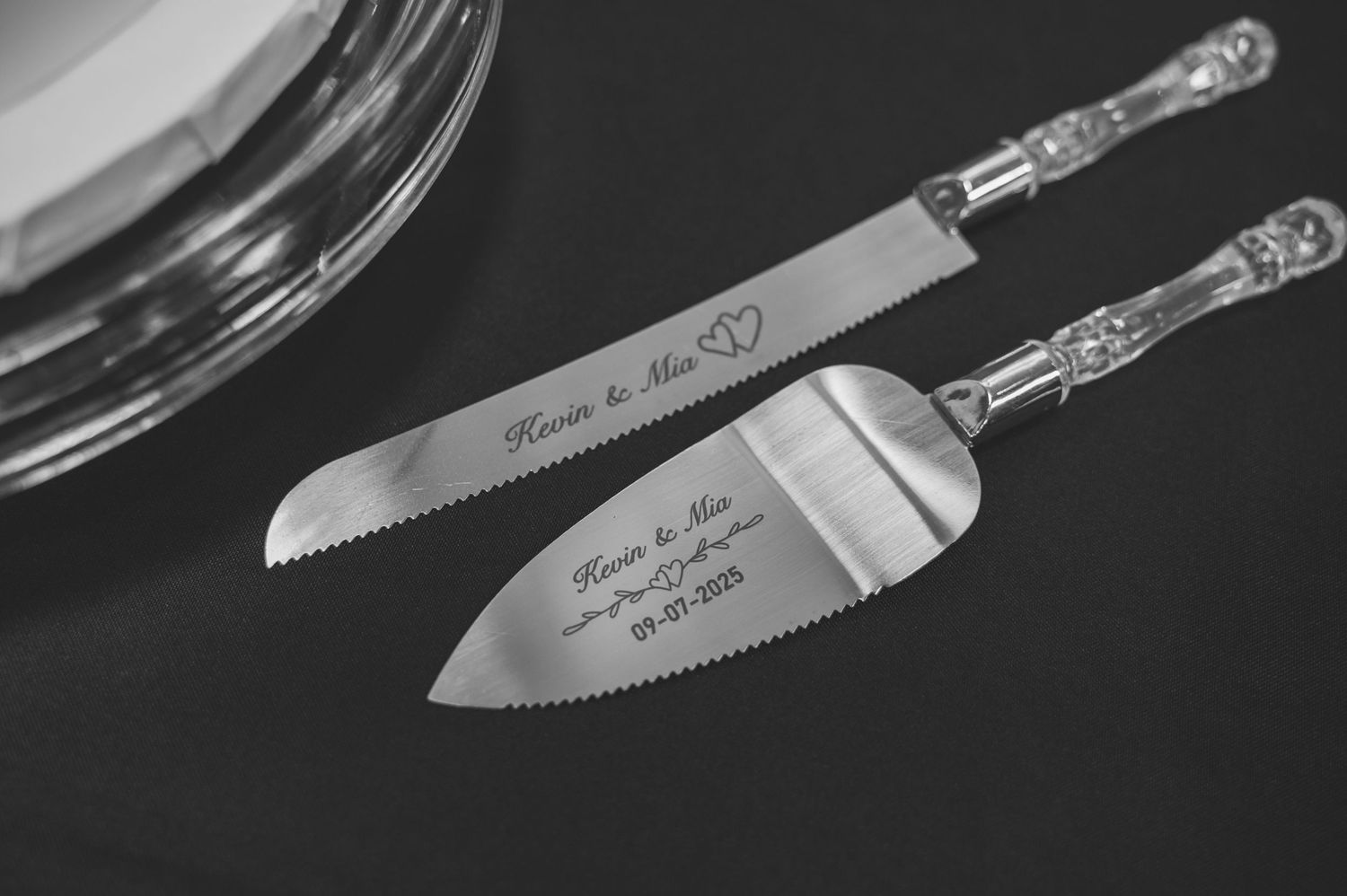 Close-up view of an ornate silver knife handle with intricate decorative patterns against a dark background.