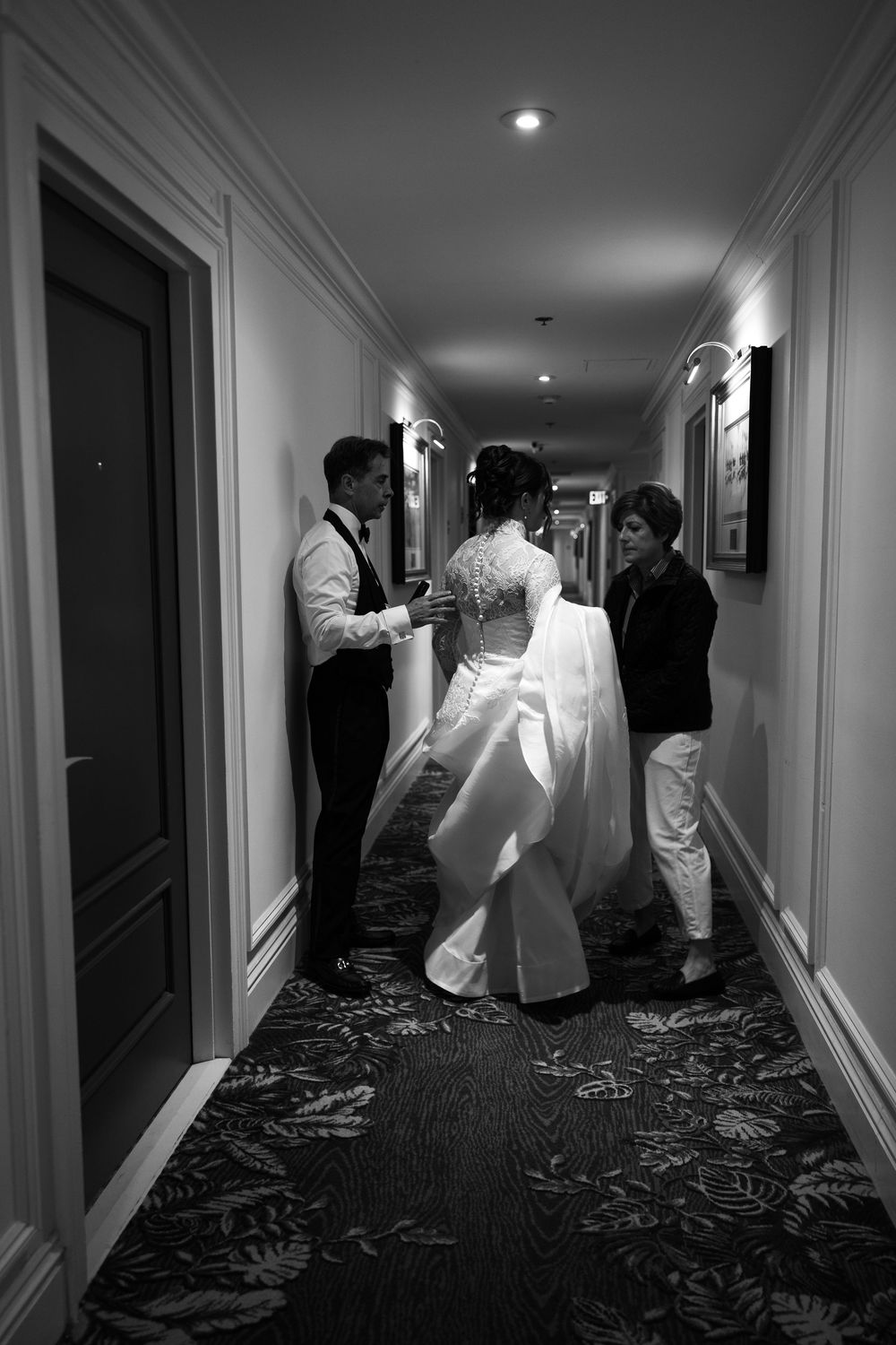 Black and white photos show wedding party preparations in a hotel hallway.