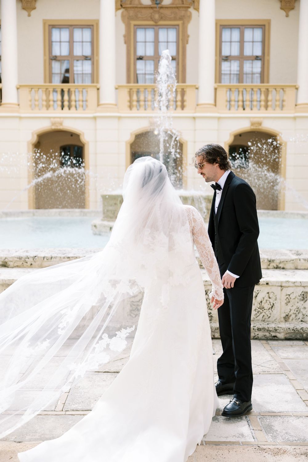 A romantic wedding sequence showing a couple in formal attire sharing intimate moments against an elegant architectural backdrop.