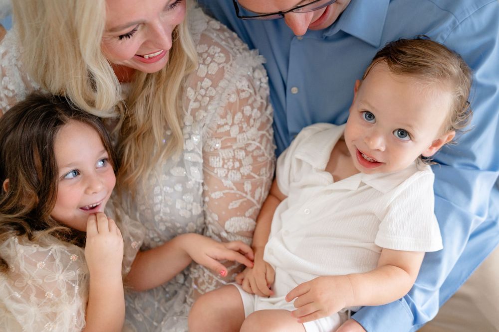 Tender family moments captured in a series of intimate indoor portraits showing affectionate embraces.
