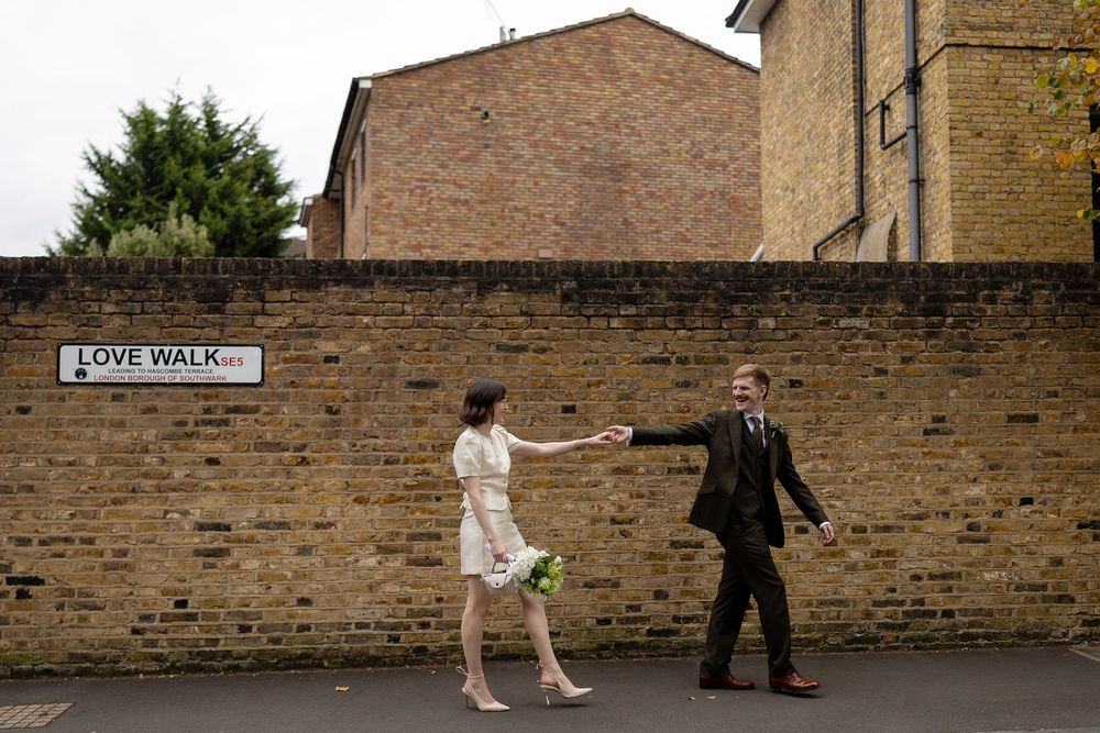 People walking along a brick wall on a sidewalk in a sequence of progressive motion shots.