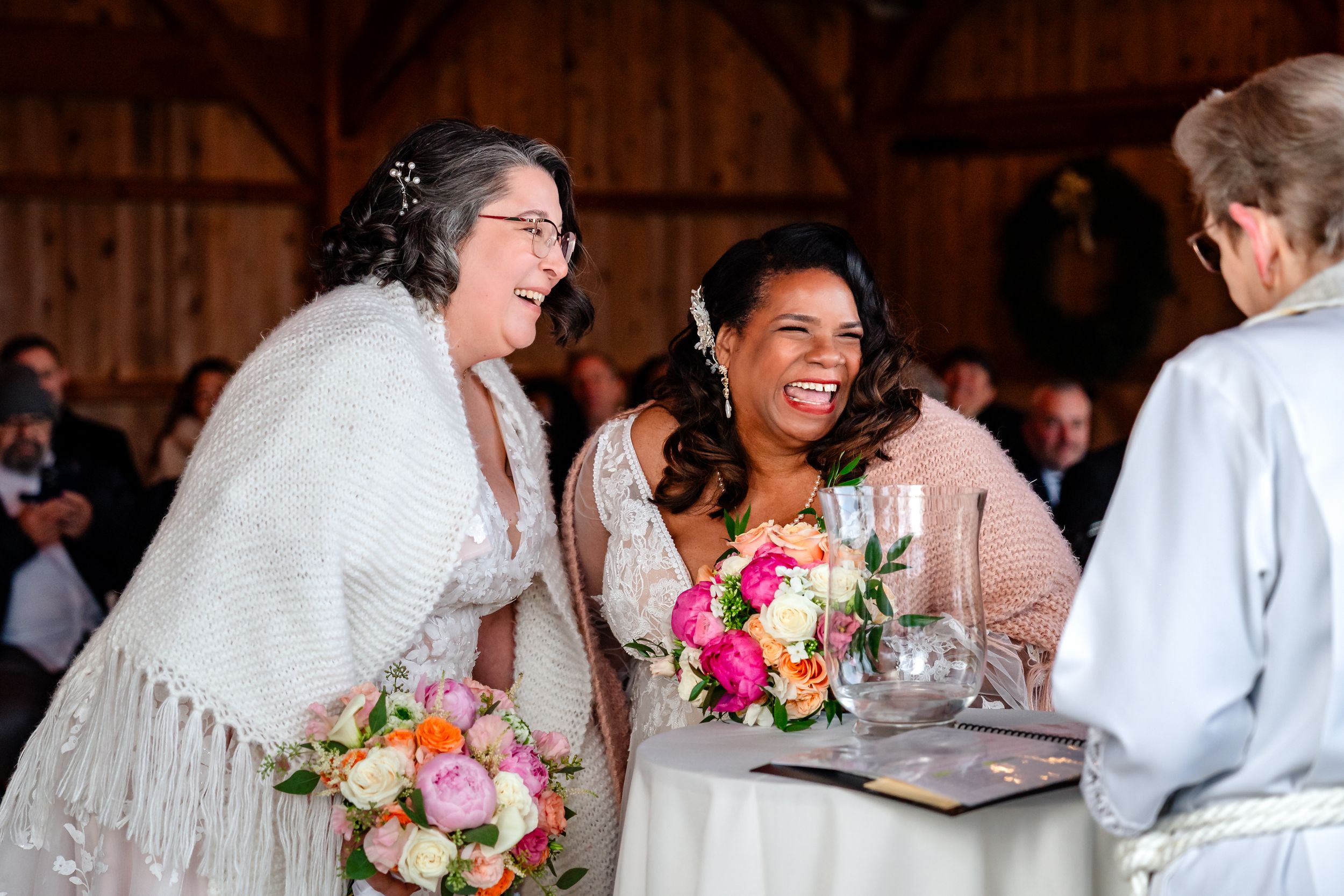 Joyful wedding celebration moments captured inside wooden barn with natural lighting.