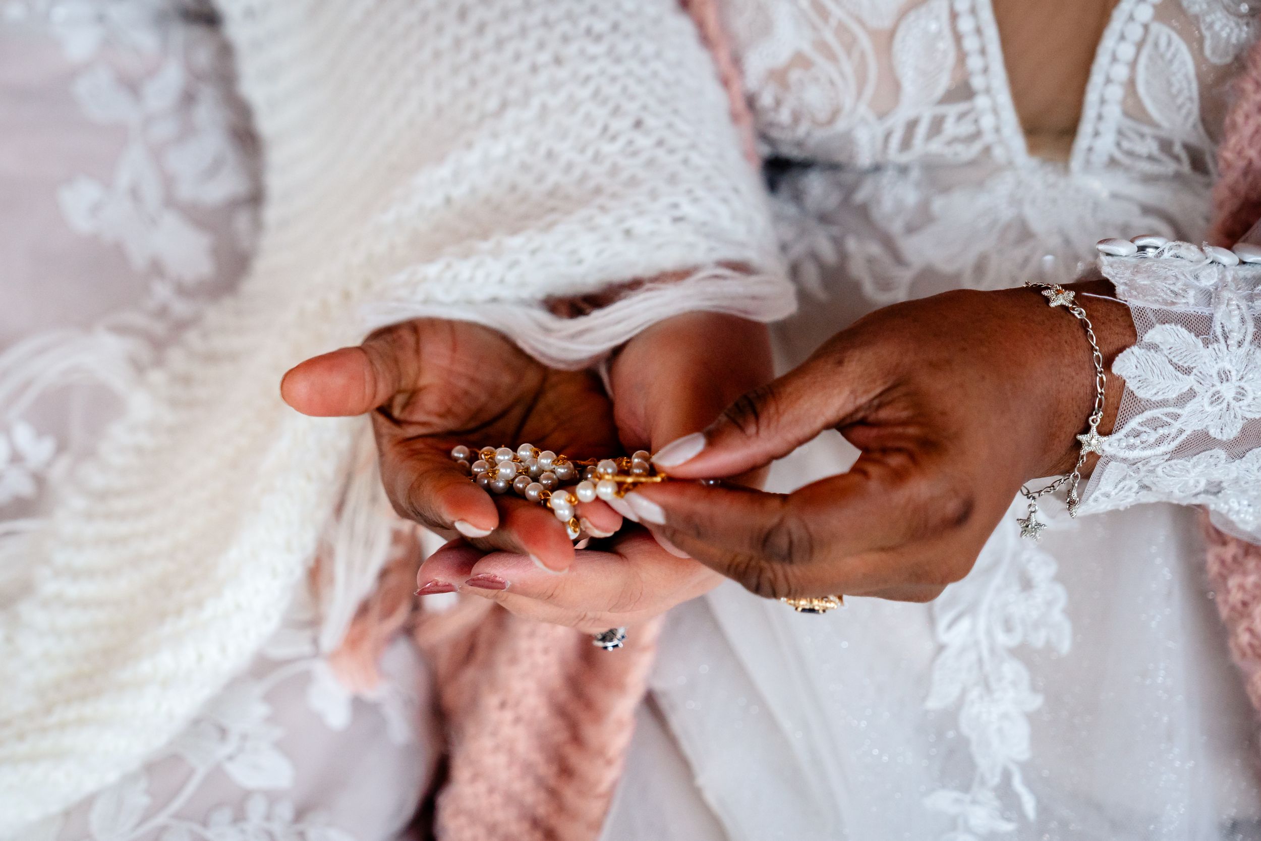 Close-up details of intricate lace wedding dress with delicate hand stitching.