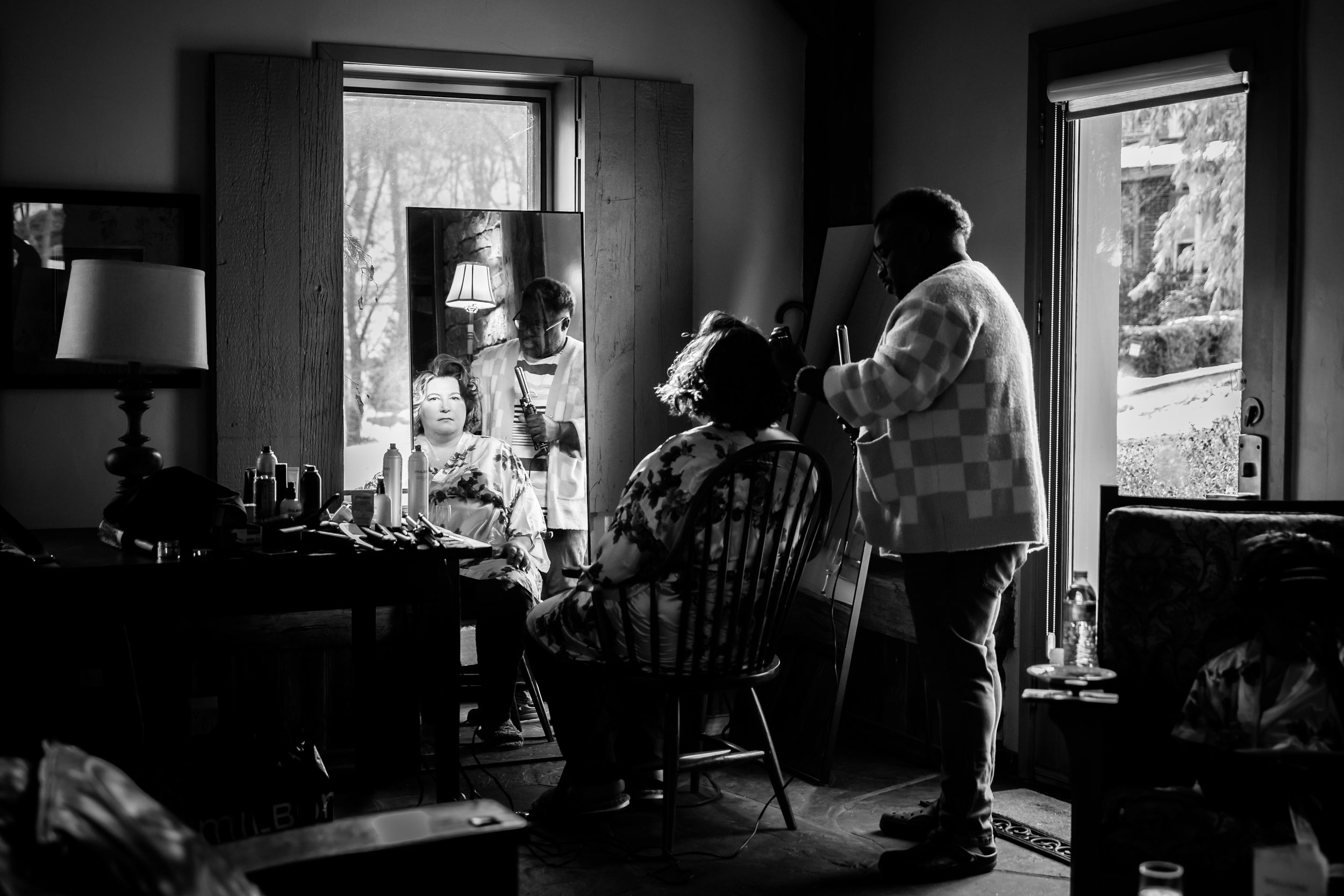 A moody black and white photo series showing various interior rooms lit by window light in dramatic shadows.