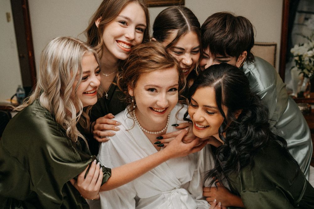 A collage of candid wedding moments showing joyful embraces and laughter among a group celebrating together.