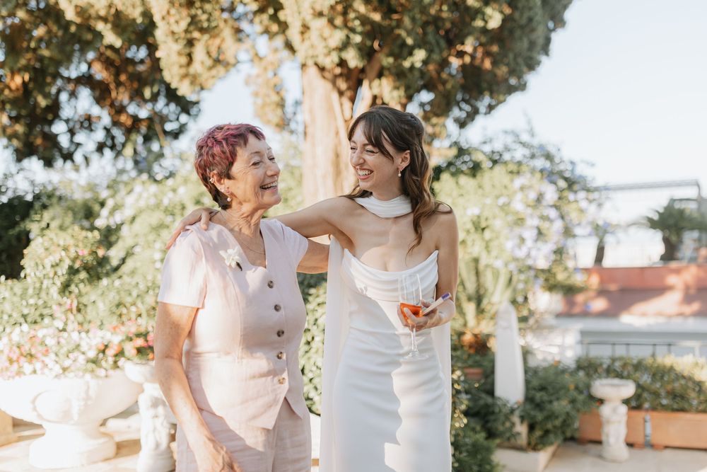 A couple shares a joyful moment together outdoors during a wedding photo session in natural sunlight.