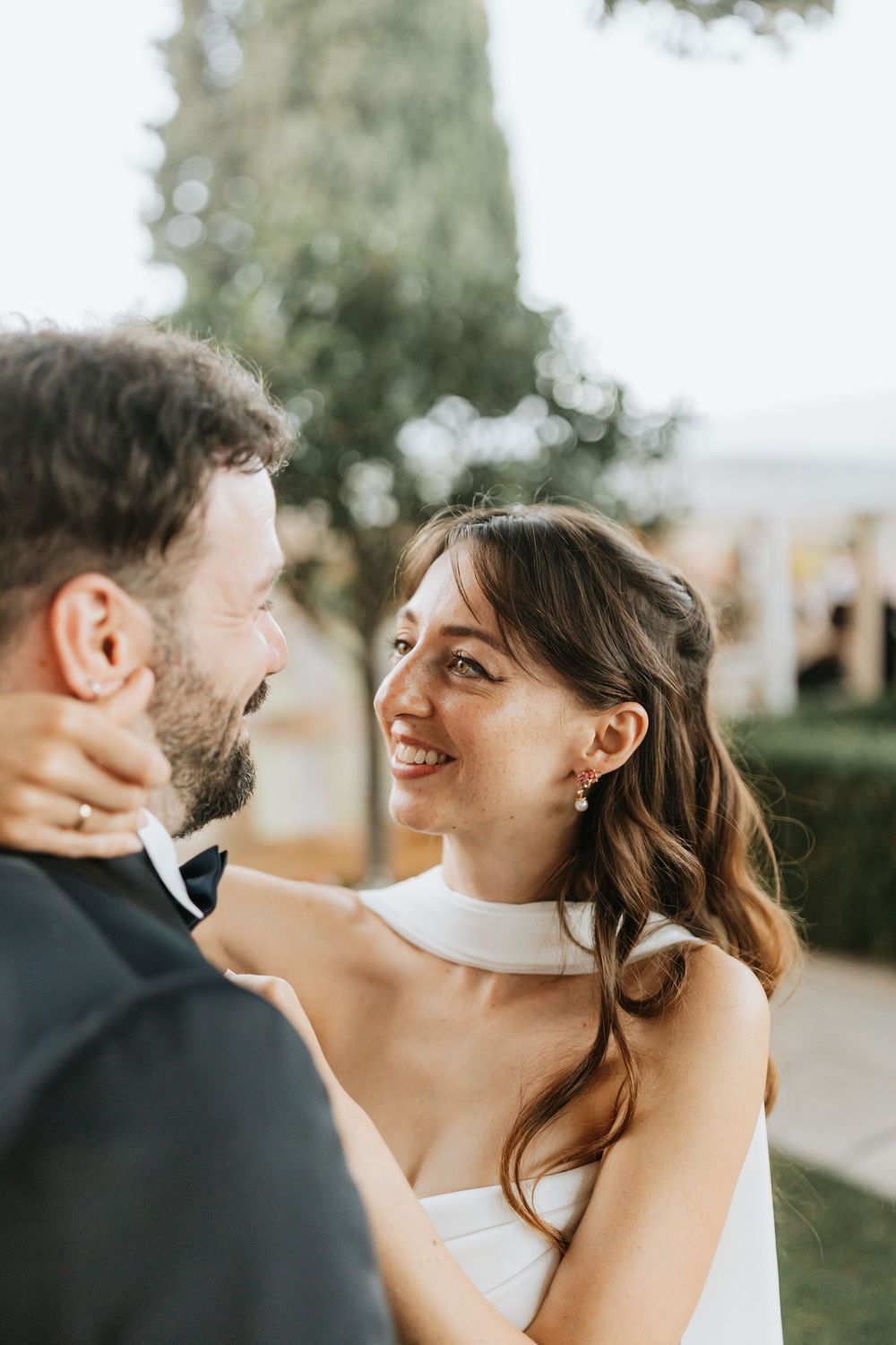A romantic wedding couple shares intimate moments during their sunset photo session outdoors.