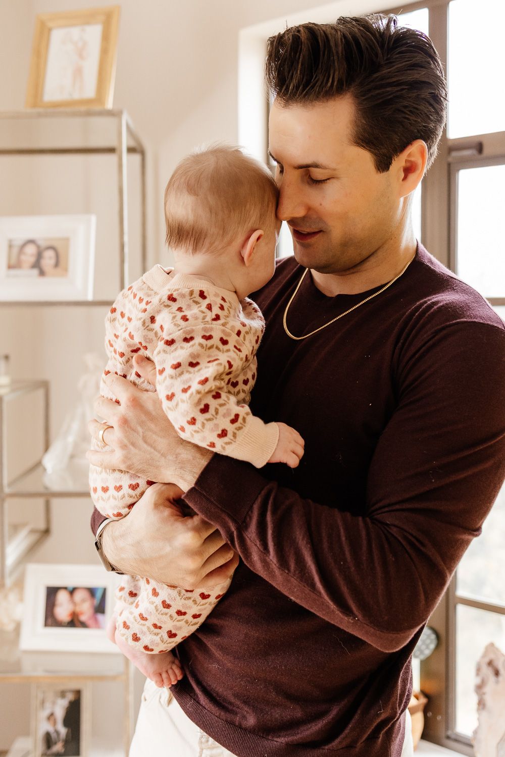 A dad holds his baby close at their in-home photography session in Los Gatos