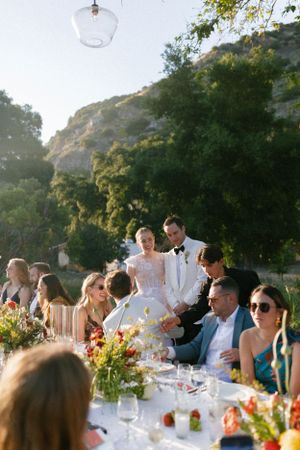 Guests gathered at an elegant outdoor reception table with mountain views.