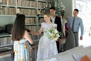 Wedding preparations in a room with vinyl record collection in the background.