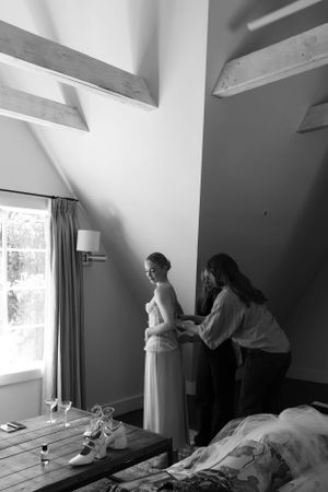 A quiet moment of wedding preparation in an attic room with angled ceilings.