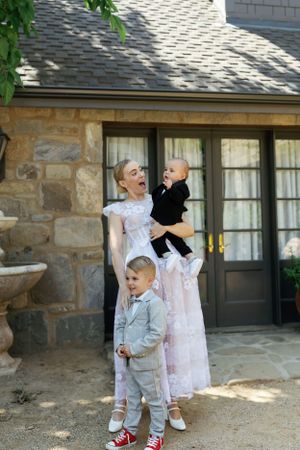 A sweet family moment captured outside a charming stone cottage.