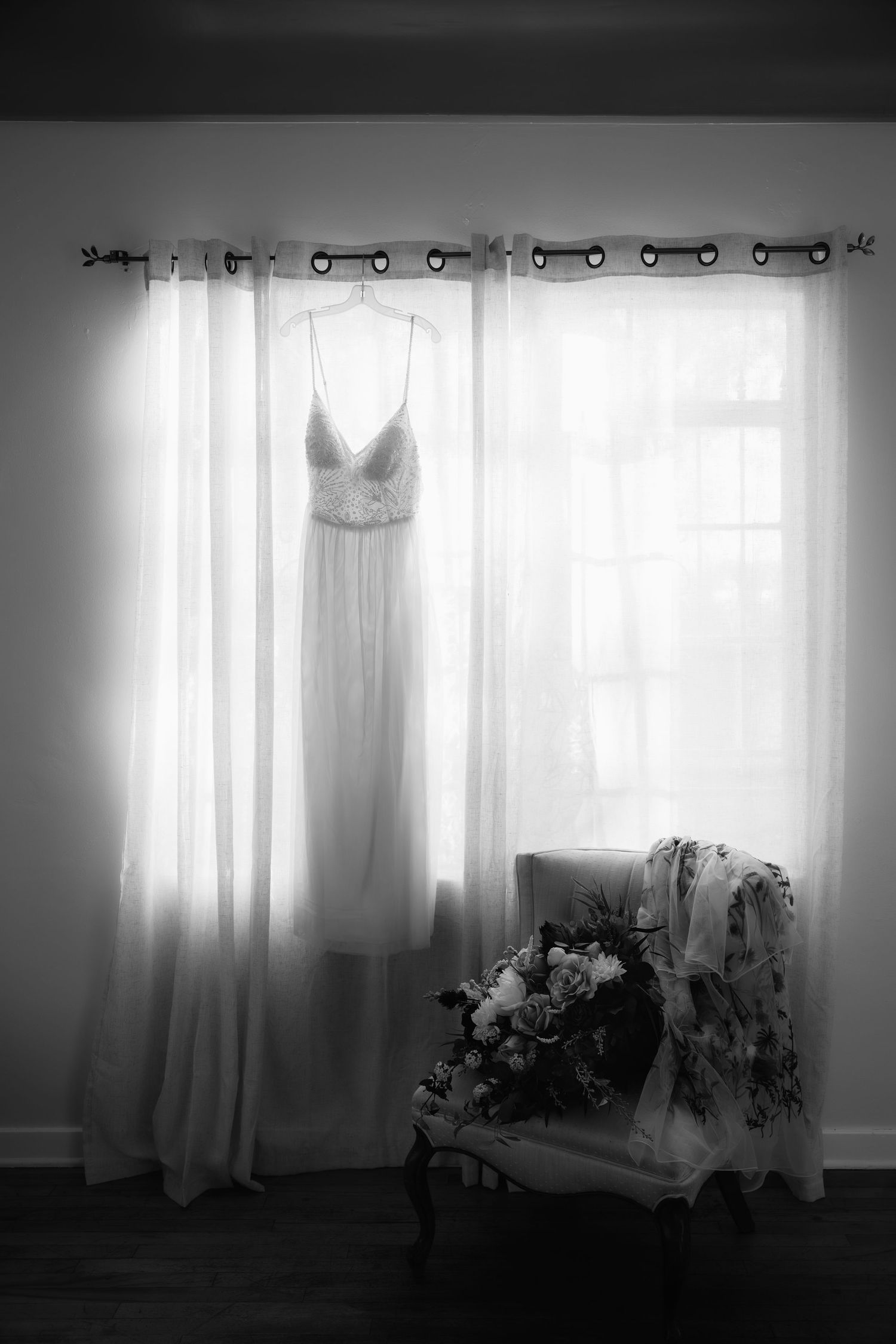 A sequence of sepia-toned images showing a wedding dress hanging in front of sunlit windows with sheer curtains.