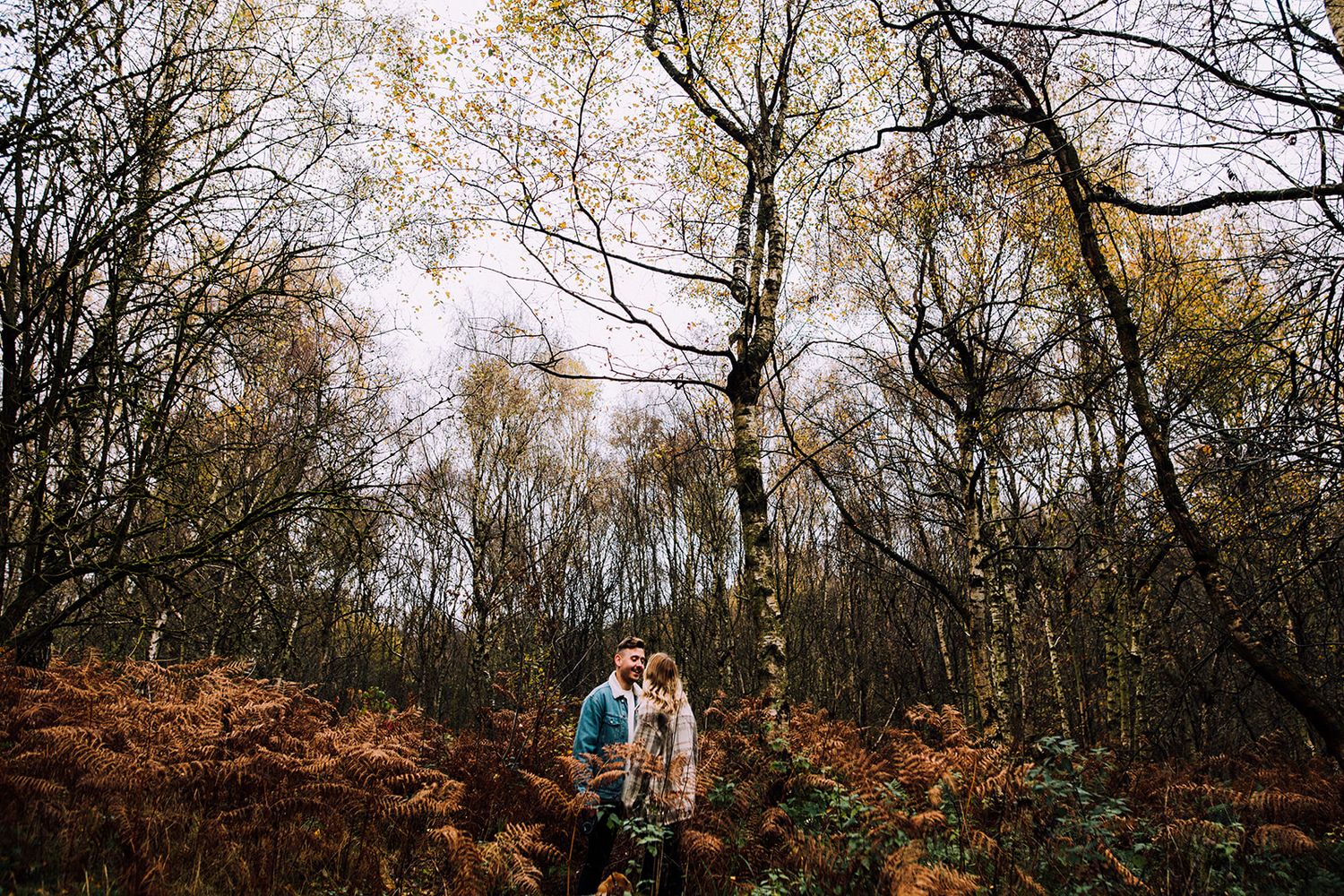 Black and white photographs show a group of people with cameras taking pictures along a path in nature.