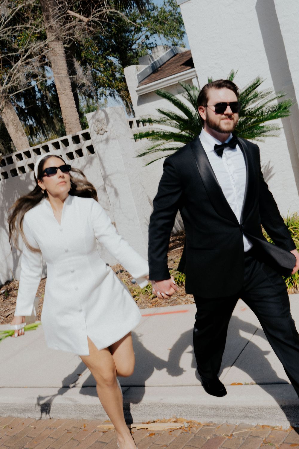 A playful sequence of outdoor wedding photos with palm trees and white architectural elements in the background.