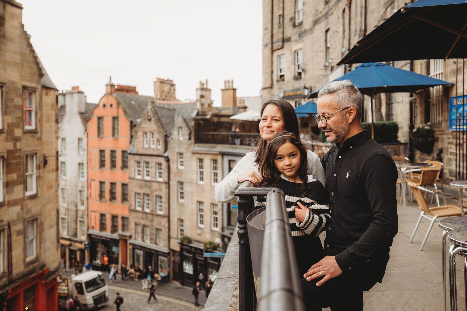 A collection of photos showing people walking and exploring the historic cobblestone streets of Edinburgh, Scotland.