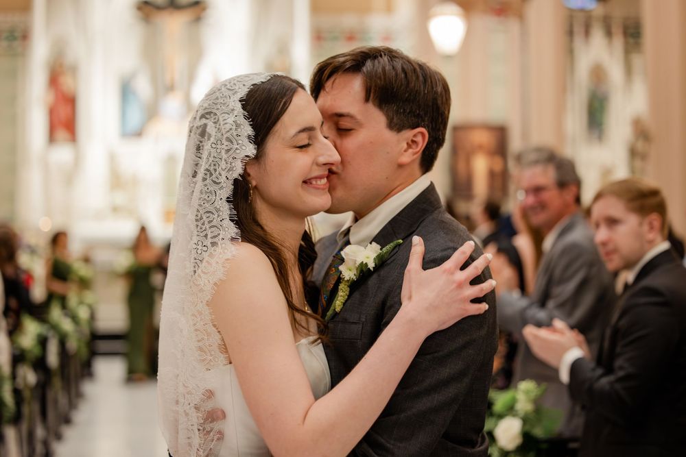 Couple shares intimate dance moment at elegant church wedding reception.