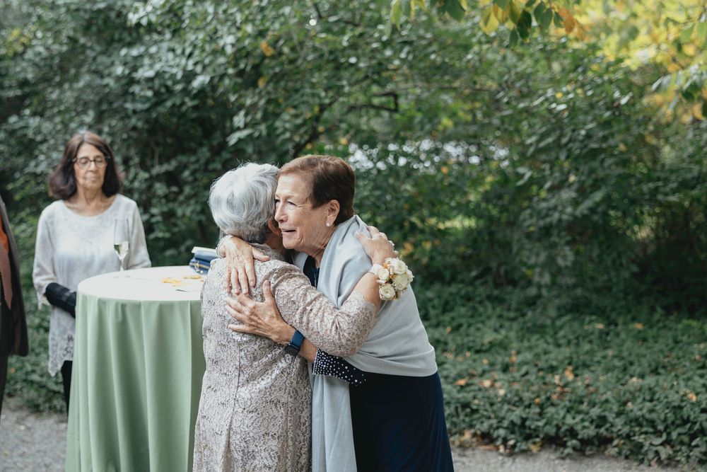 Wedding celebration in a lush garden setting with soft green decor and natural outdoor ambiance.
