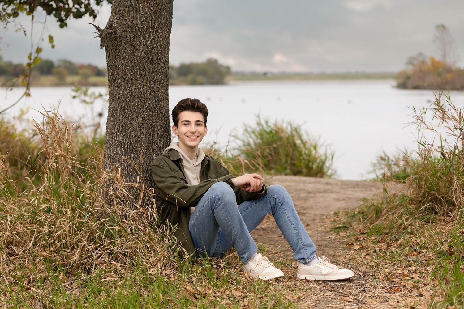 A series of cropped nature photos showing tree trunks, grass, and feet sitting by a lake or pond.