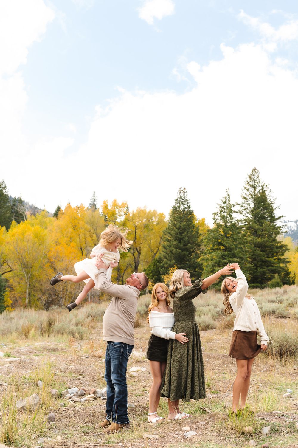 A playful sequence of four outdoor family photos showing joyful interactions against a backdrop of autumn trees and grass.