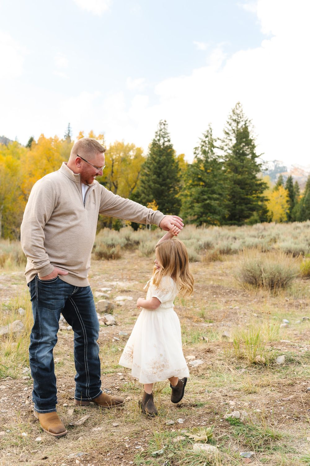 A heartwarming sequence of playful interaction between two people in a scenic autumn field with golden trees.