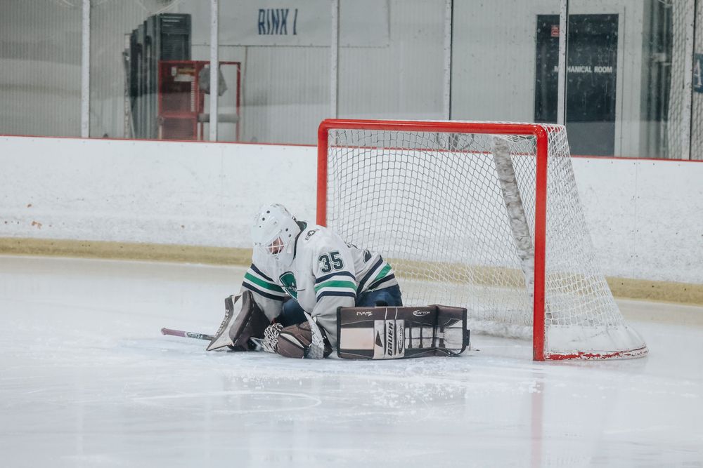 Hockey rink with empty goal nets visible during team practice session.