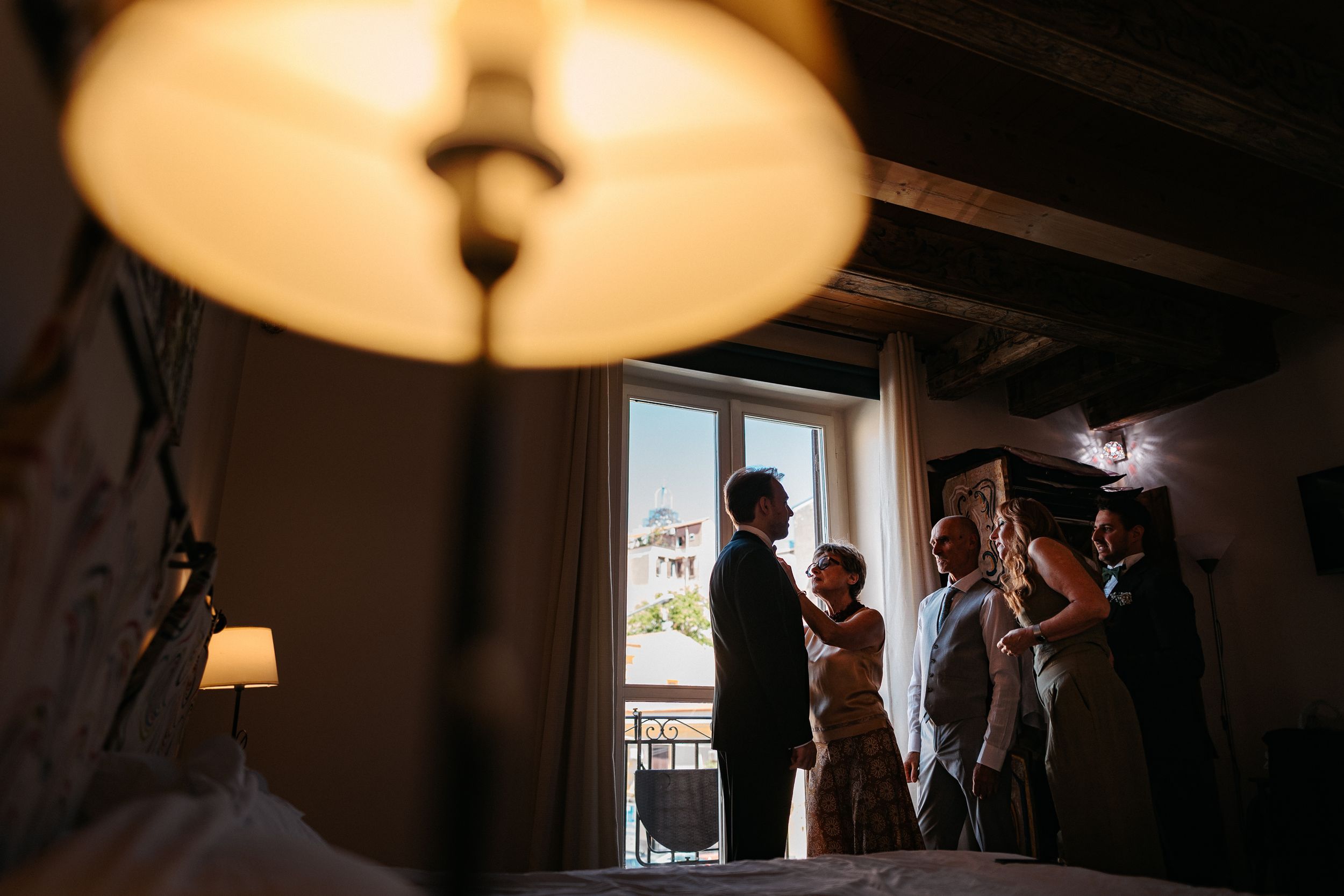 A series of wedding preparation photos showing silhouettes against window light in various indoor settings.