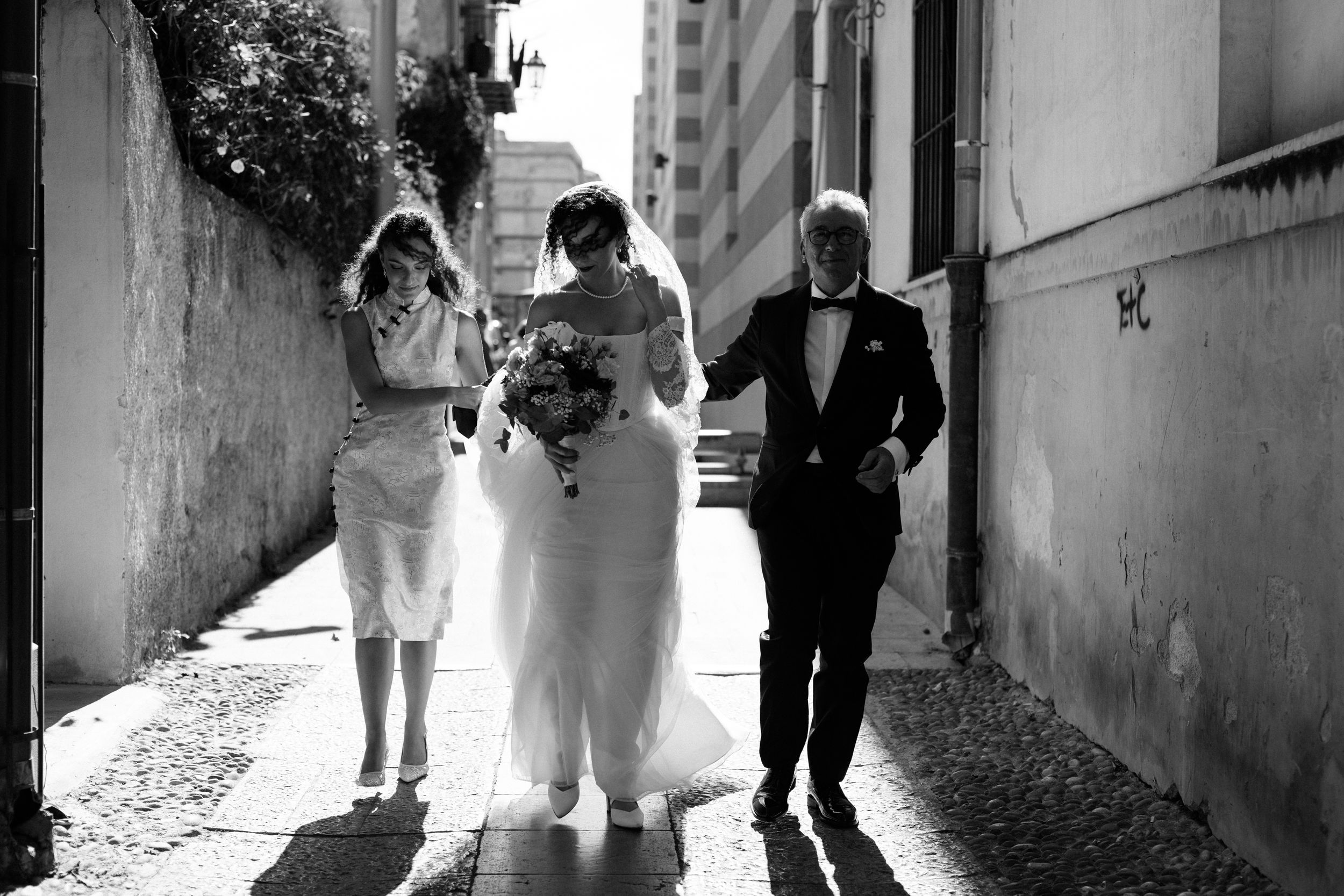 Black and white photo collage showing people walking through urban alleyways and passageways in various poses.