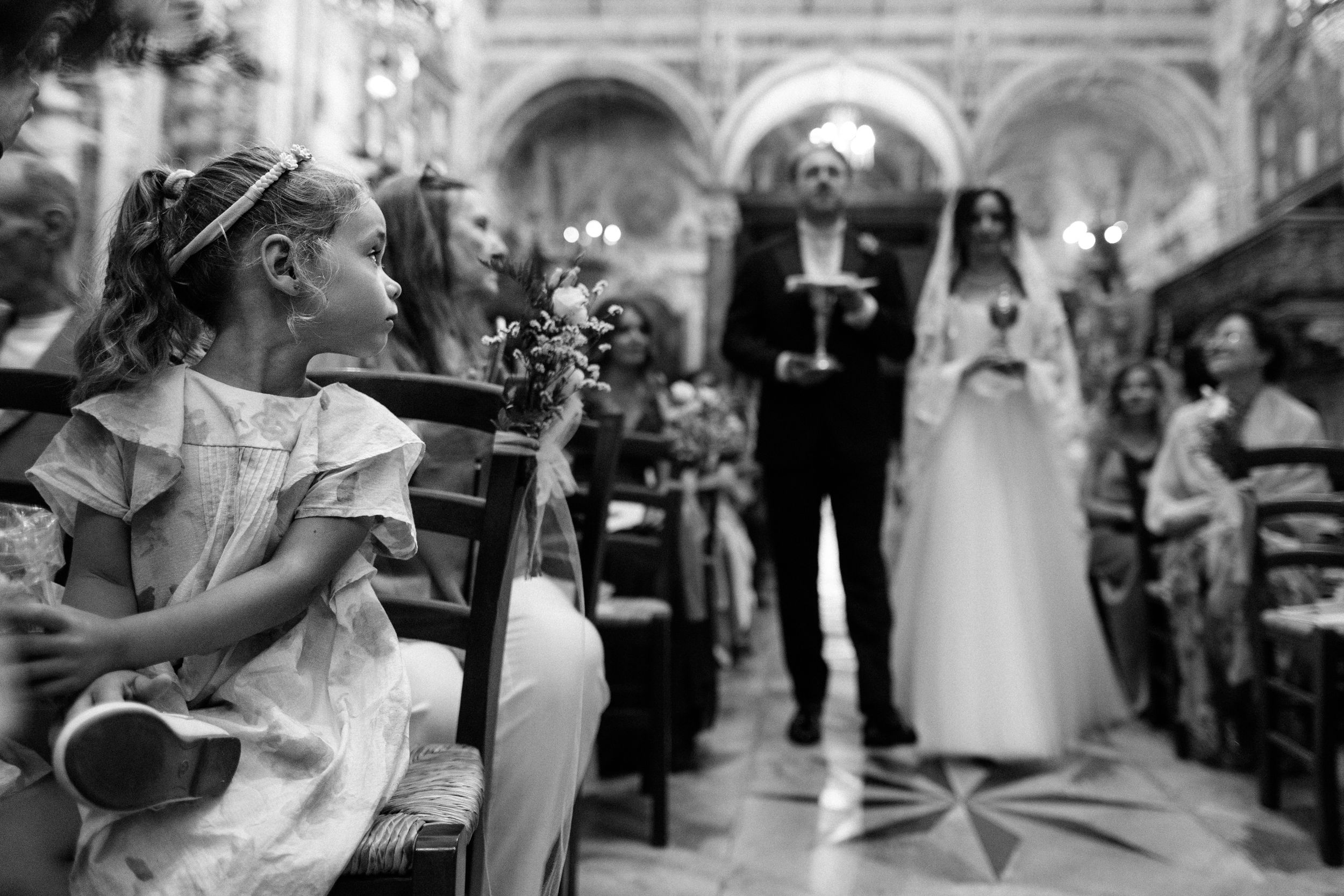 Wedding couple shares their first dance surrounded by guests at an elegant reception venue.