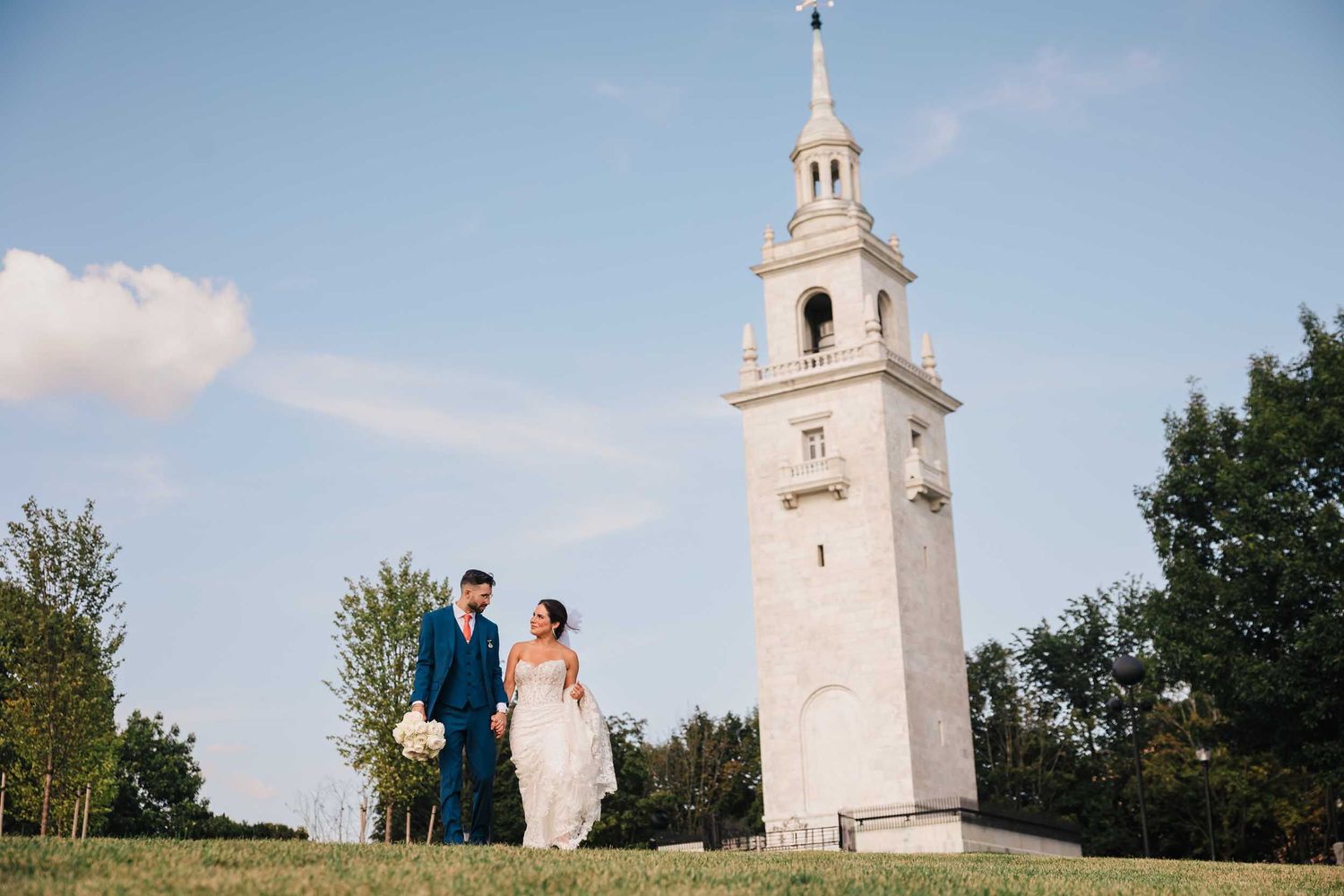 Bride and groom walking near the Dorchester Heights Monument during wedding portraits in South Boston