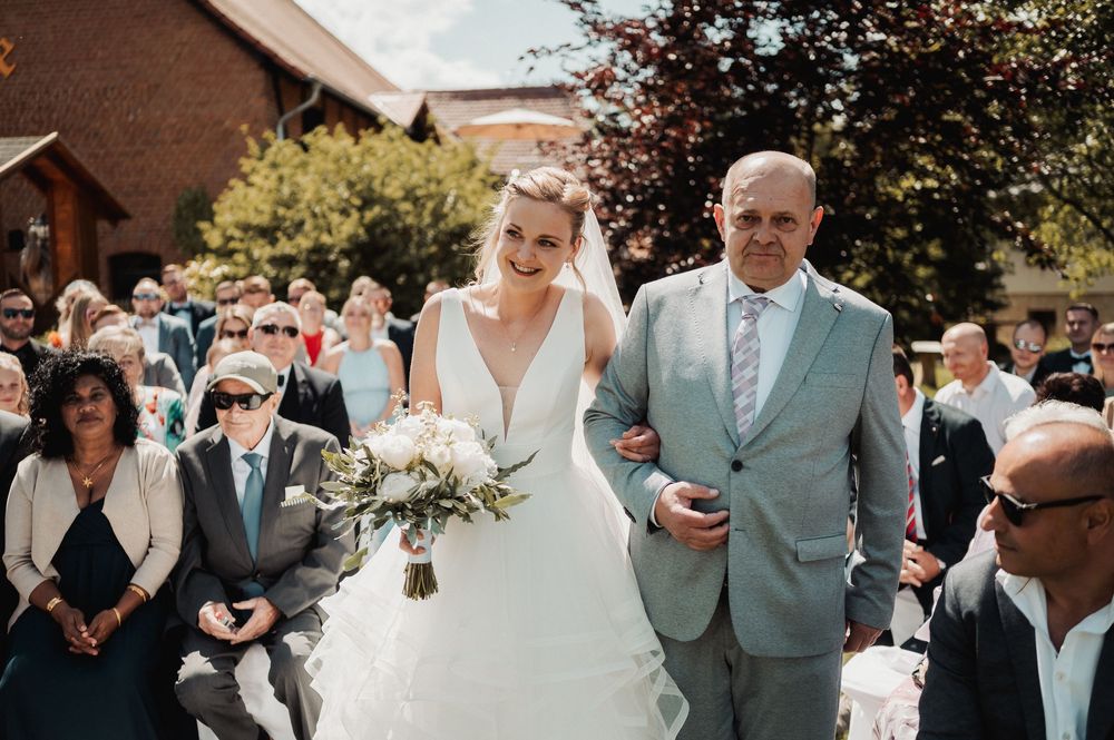 A collection of wedding photos showing couples and guests celebrating at an outdoor ceremony and reception.