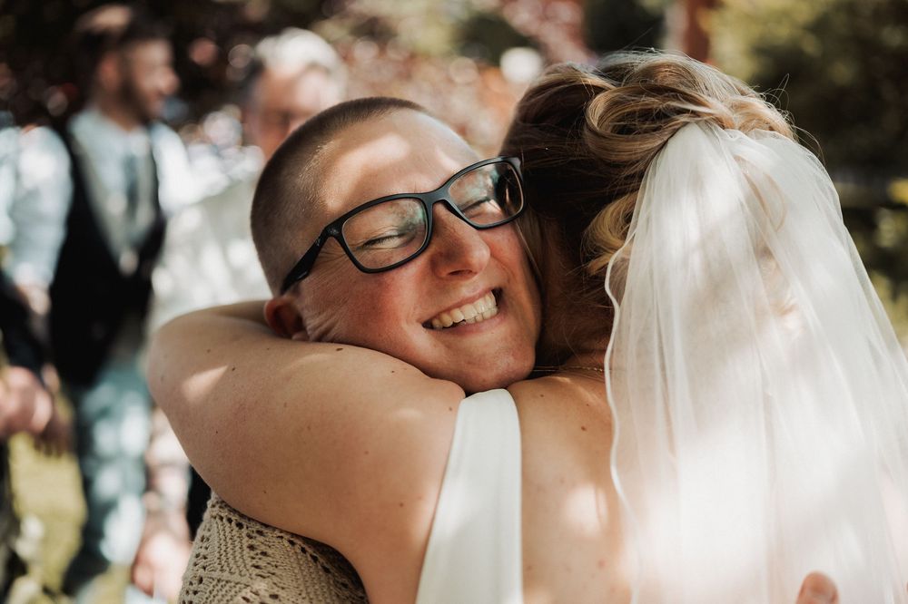 Close-up candid moments of joy and celebration at an outdoor summer wedding ceremony.