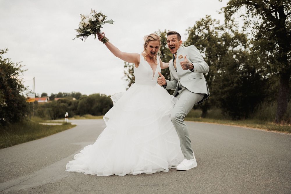 A sequence of wedding photos showing a couple in formal attire dancing and twirling on an empty country road.