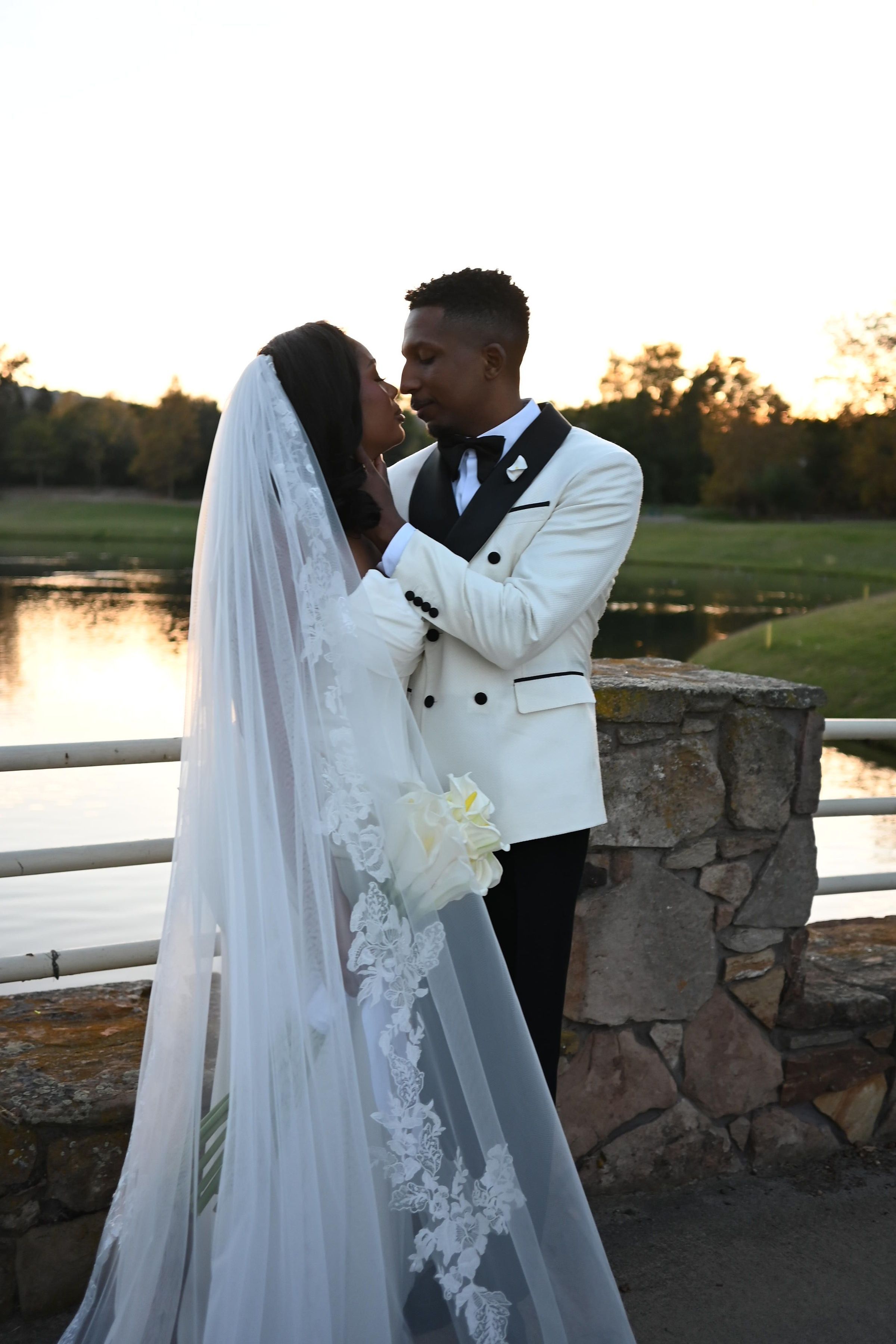 Newlywed couple shares romantic sunset kisses in four similar poses against a stone wall backdrop at golden hour.