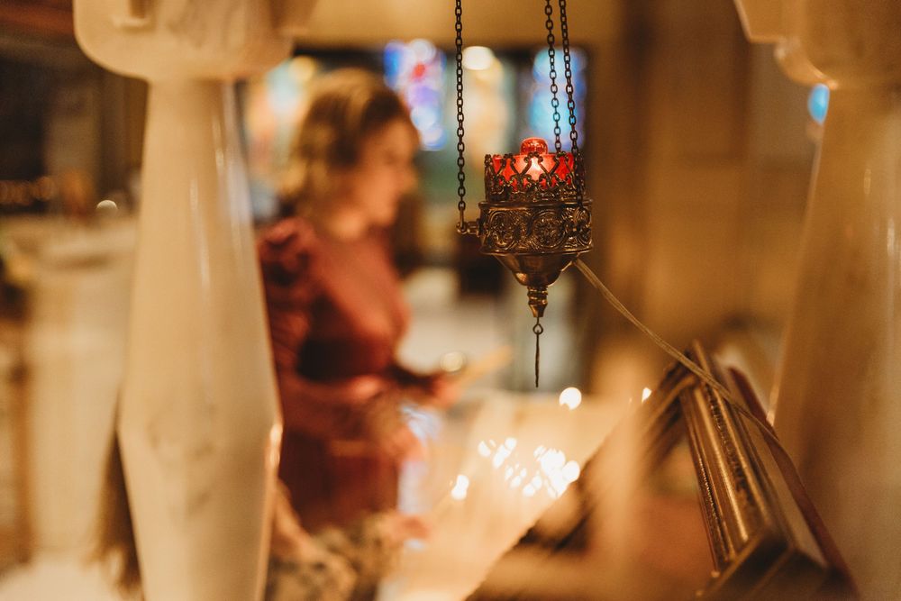 A close-up view of lit candles creating a warm, romantic ambiance in an elegant restaurant setting.
