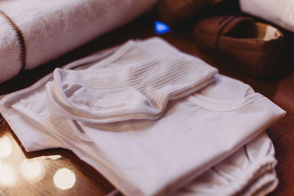 Neatly folded white linens arranged on a table setting.