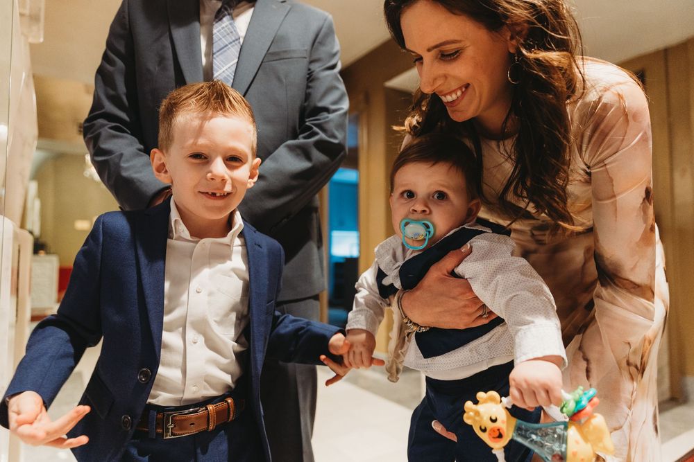 A candid family moment at a formal event with people smiling and laughing together.
