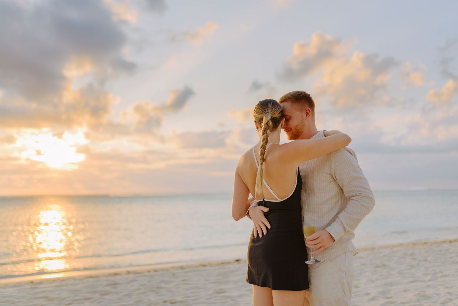 Romantic beach photoshoot with sunset and ocean views.